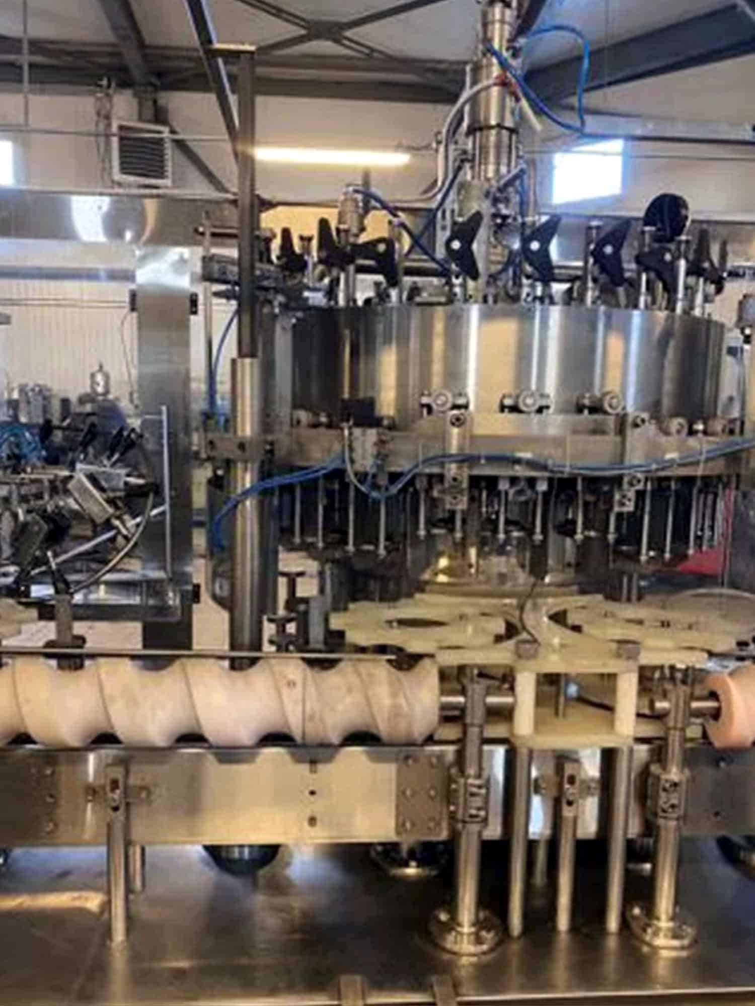 Left view of Melegari TriBlock (rinser, filler, capper)
